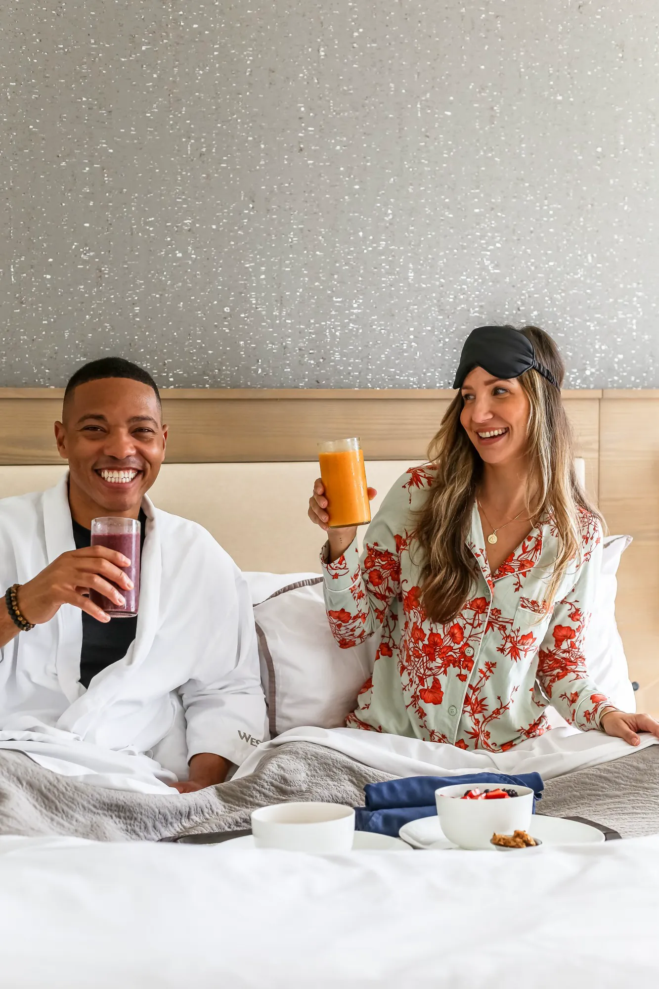 A couple enjoying a relaxed breakfast in bed at The Westin