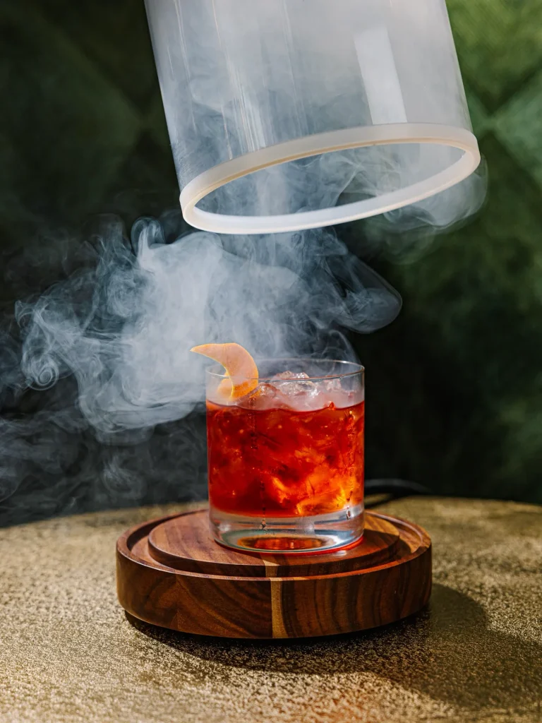 Smoke lifting from a freshly prepared cocktail