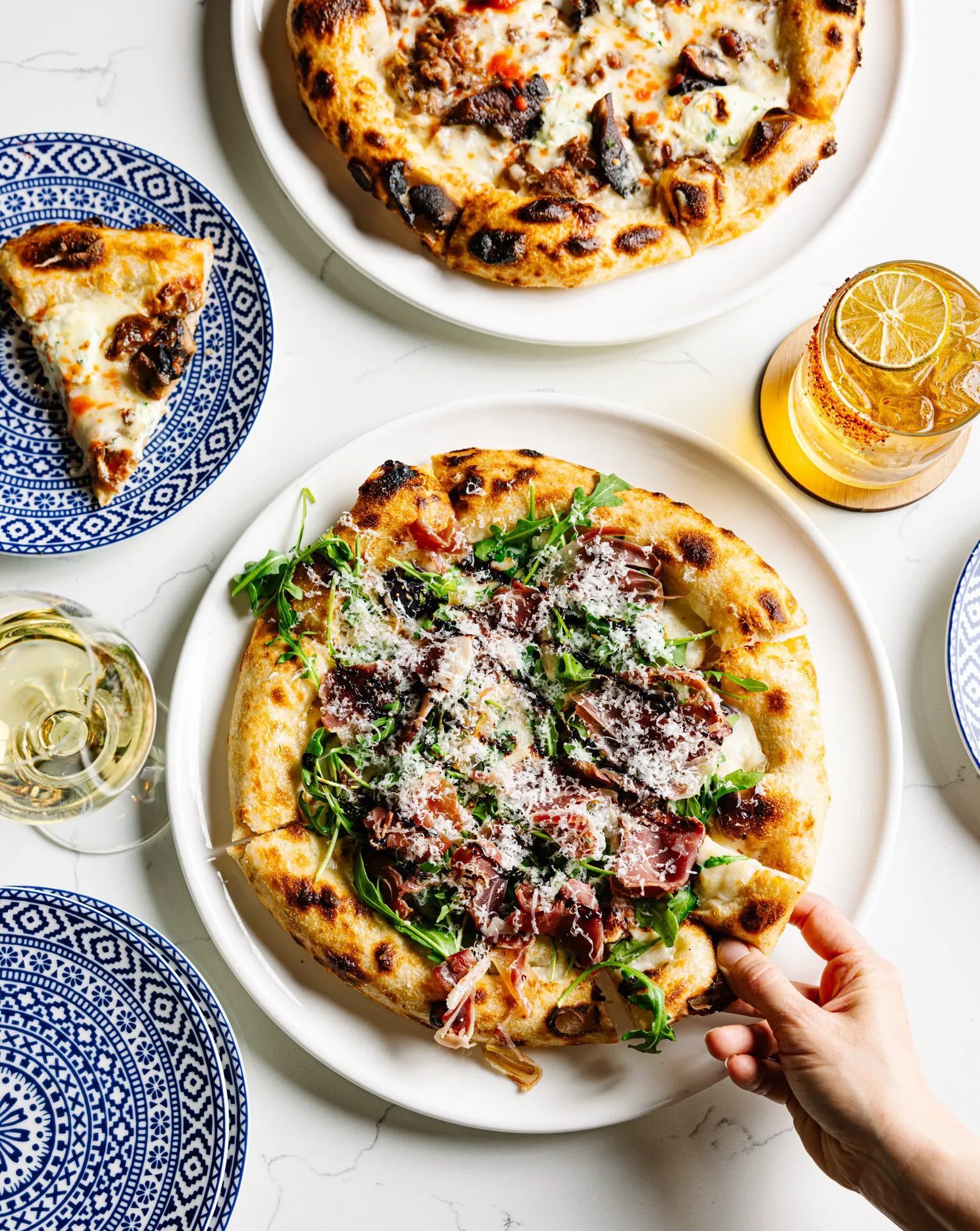 Wood-fired pizzas served with cocktails