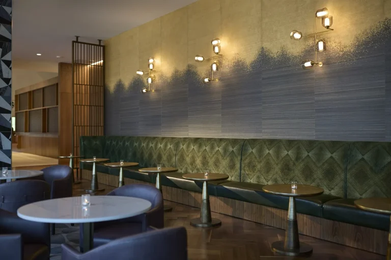 A Westin lounge with green banquette seating and warm lighting
